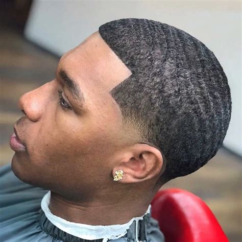 The waves haircut is a style for black men that takes kinky curls and defines your hair into deep ridges and spirals all around the head. . Burst fade with waves